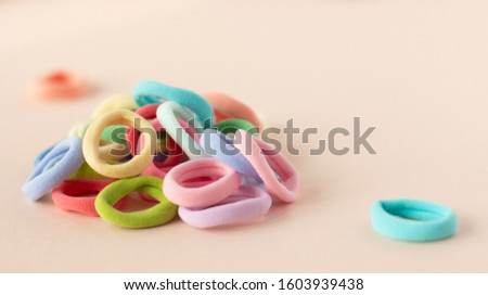 Many different colors of scrunchy on the soft beige background
