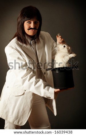 illusionist with white rabbit in black top hat