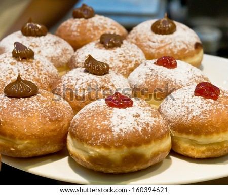 Fresh donuts with jam and chocolate in a market bakery during the Jewish holiday of Hanuka