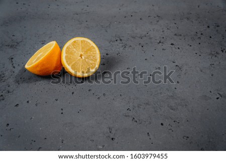 Lemon on stone background. Acid lemon used for tea. The concept of using a lemon.