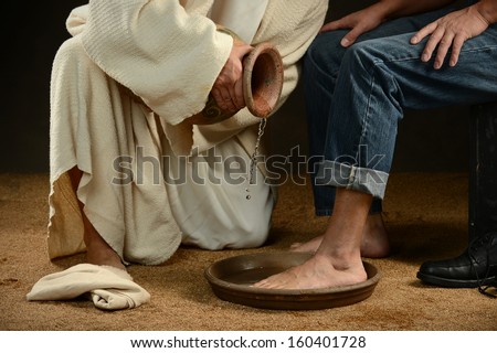 Jesus washing feet of modern man wearing jeans Royalty-Free Stock Photo #160401728