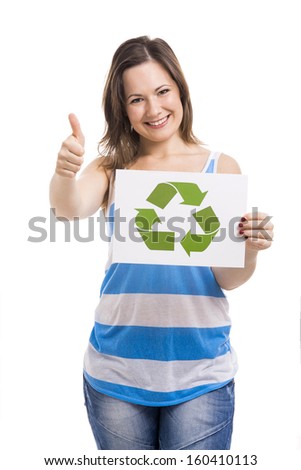 Beautiful young woman holding a paper card with the recycling symbol, isolated over white background