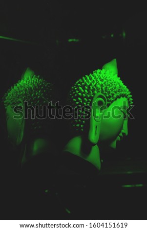Abstract buddha face with reflection and dark background
