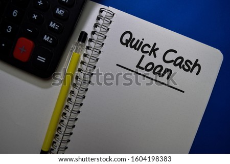 Quick Cash Loan write on a book isolated on Office Desk