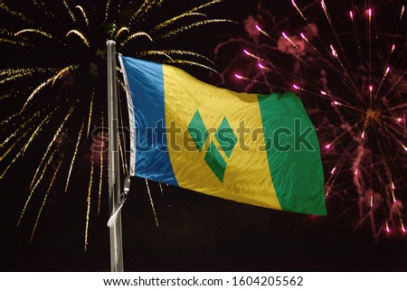 Saint Vincent and the Grenadines flag blowing in the wind at nig