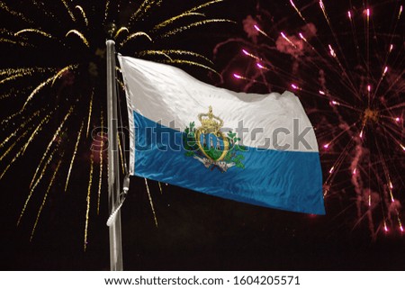 San Marino flag blowing in the wind at night