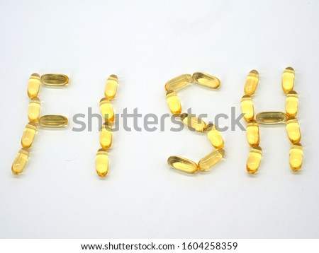 The word FISH laid out from omega 3 fish oil capsules on a white background