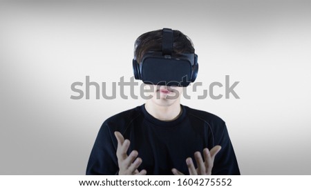 man touching air during the VR experience virtual reality isolated on gray background