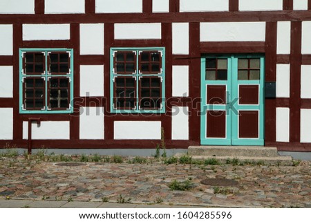 A picture of the historical brick family house in Klaipeda in Lithuania. The detail of the half-timbered frontage.