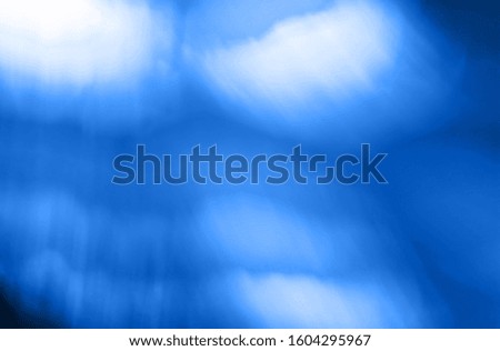 Classic blue colour of 2020 abstract glowing light gradient defocused background.