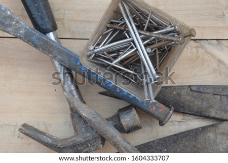 old construction of a house and repair tools on wooden background
