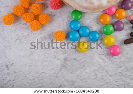 Much multicolored candies placed on a white background.