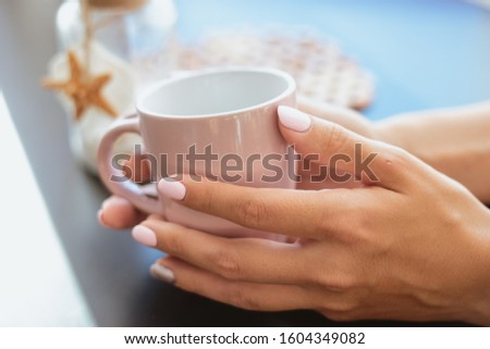 Pastel tender manicure on women hands 