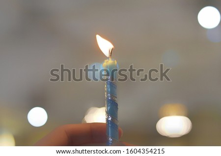 Person Holding a Small Candle - Image