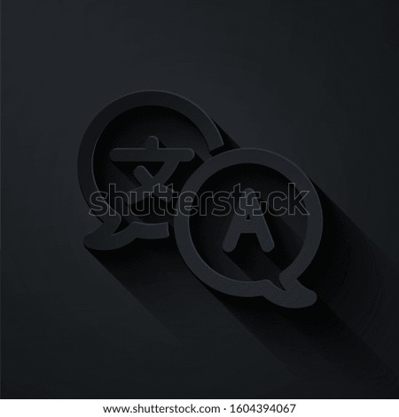 Paper cut Translator icon isolated on black background. Foreign language conversation icons in chat speech bubble. Translating concept. Paper art style. 