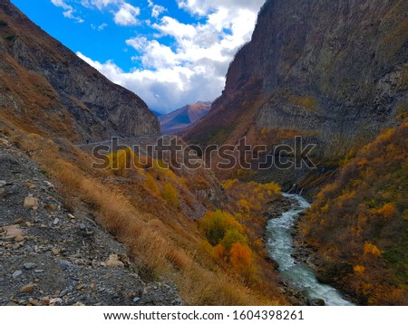 Amazing Truso valley in Kazbegi area of country Georgia. Gorgeous yellow colors of river Terek for background desktop wallpaper
