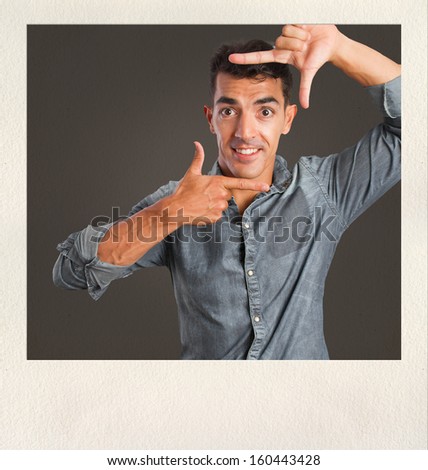  young man frame gesture on photo frame