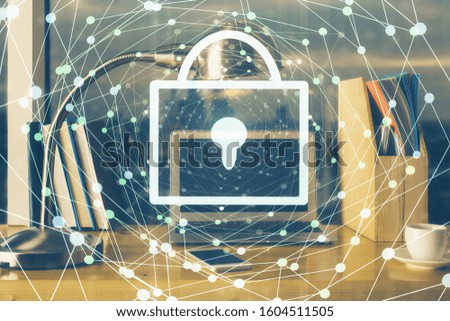 Double exposure of desktop with computer and lock icon hologram. Concept of data safety.