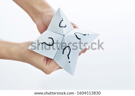 Hand in paper fortune teller isolated on white background.