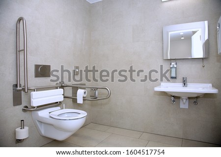Modern handicapped bathroom for the elderly and disabled, with grab bars and wheelchair access Royalty-Free Stock Photo #1604517754