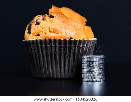 wheat cake with raisins and coins next to pastries