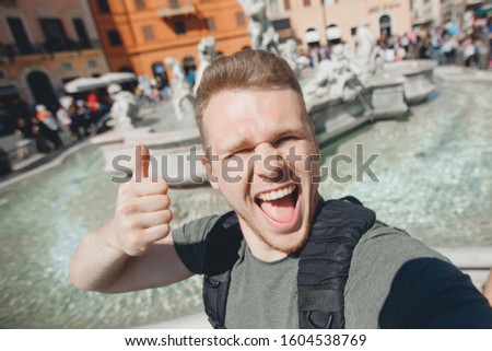 Happy man tourist taking selfie photo on background fountain Four rivers in Piazza Navona, Rome Italy.