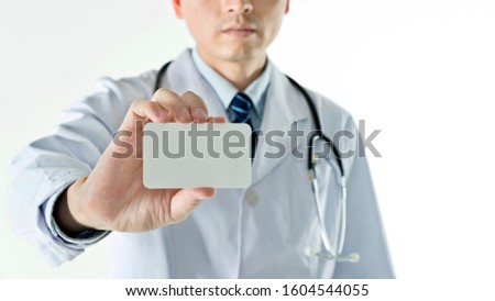 Doctor holding blank card isolated on white background.