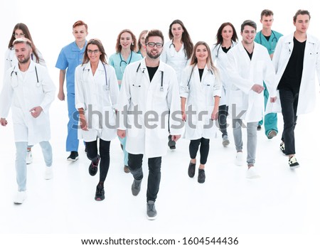 friendly doctor standing in front of a group of medical workers