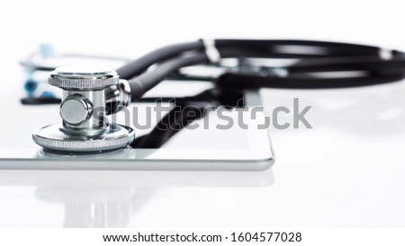 Stethoscope and digital tablet on white background.