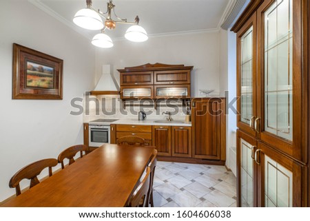 Luxury interior of kitchen in modern apartment. Wooden furniture.