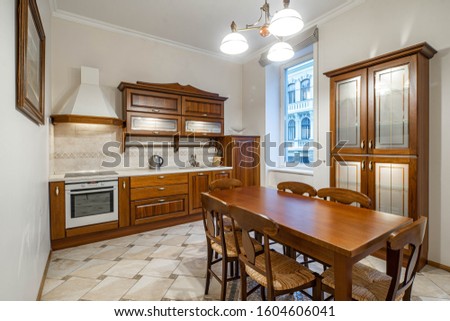 Luxury interior of kitchen in modern apartment. Wooden furniture.