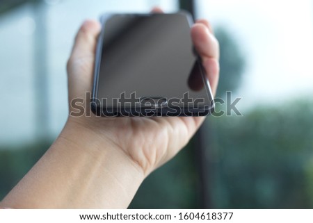 closeup on hands with black mobile smart phone broken screen mobile sceen mobile is crecked glass