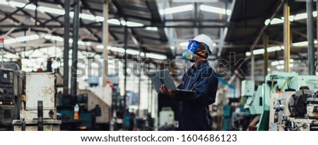 Officials from the Department of Hazardous substances control bureau is investigating the leak of a hazardous chemical in a chemical plant. Man with protective mask and computer laptops in factory Royalty-Free Stock Photo #1604686123