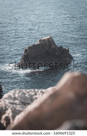 Curious composition of rocks and sea.
