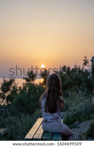 Sunset on Adriatic sea with blurred child in front, Makarska, Croatia 