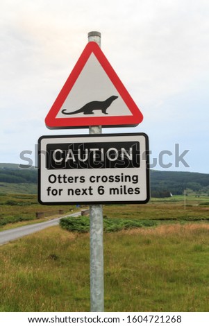 Generic British traffic sign warning road users of rare otters on a rural road on the Isle of Mull Scotland