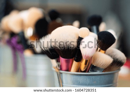 Facial brush set for makeup artist or visagist. Natural soft brushes standing in a pot. Close up macro photo of professional makeup brushes