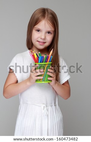 Cute child with colored pencils