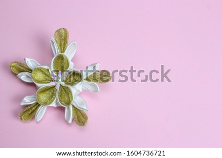 Japanese kanzashi, handmade flowers on pink background