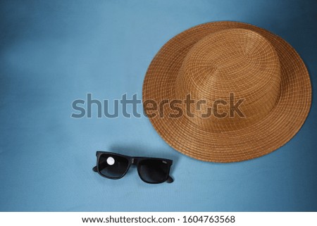 Traveler's accessories, chapel sunglasses for summer with empty space for text. Travel vacation concept. Summer background. Road frame set. Lay flat, top view.