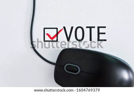 Computer mouse and vote on paper.