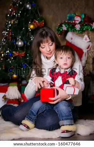 mother and son opening christmas gifts