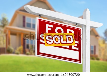 Sold Home For Sale Real Estate Sign in Front of Beautiful New House.