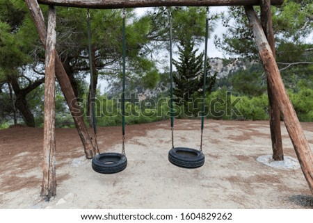 Two car tire swings on trees. Beautiful North Cyprus mountain landscape