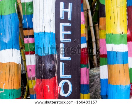 Art abstract painting on wood pole background with "hello" wording