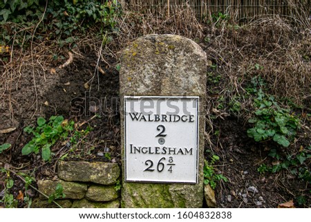 Roundtop milestone marker along the Thames and Severn Canal showing Walbridge 2 miles Inglesham 26 3/4, Stroud, Gloucestershire