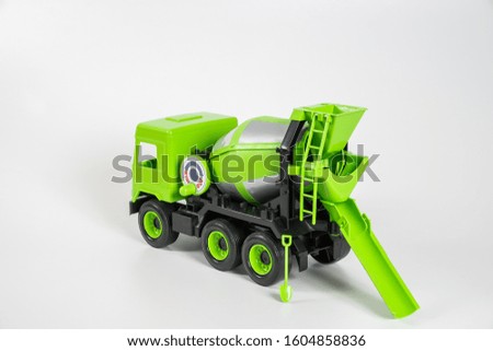 Plastic car. Toy model isolated on a white background. Green truck for transporting concrete.