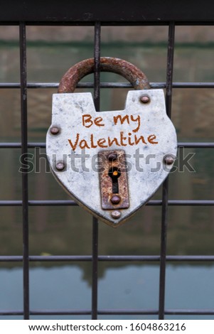 lock, heart shaped hanged love padlock on a fence of a bridge for valentines day. padlocks hung as iconic symbol that lovers or spouses' love will last forever concept, idea photo