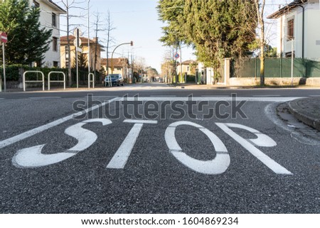 the stop painted on the road surface
