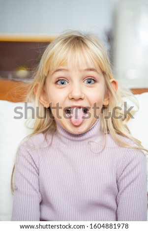 Adorable kid making funny face stock photo